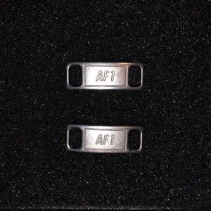 Nike metal shoelace tag locks.